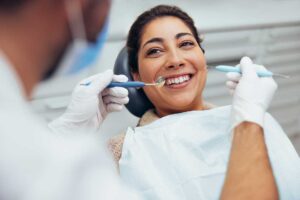 Adult brushing teeth in a well-lit home bathroom using an electric toothbrush